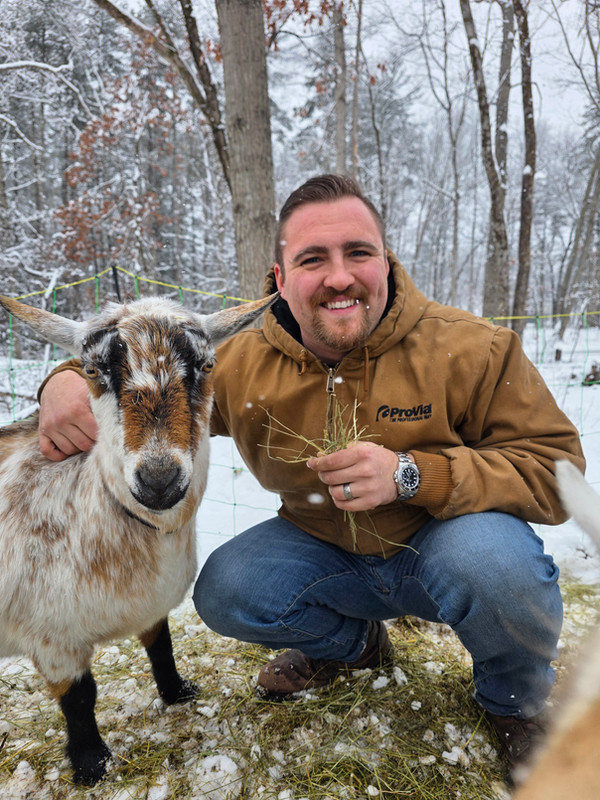 Victor with a goat on the homestead